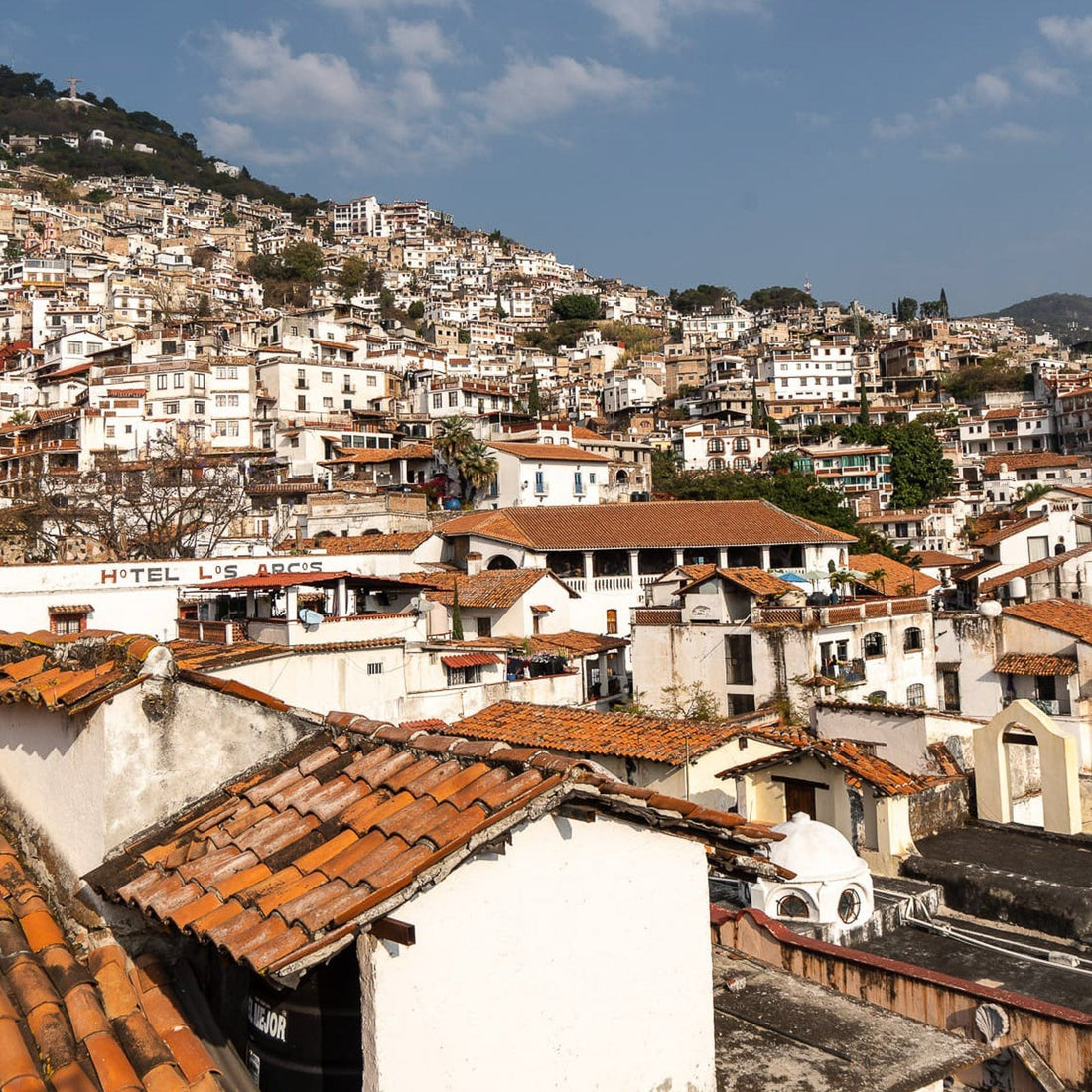 Taxco Mexico hillside with white buildings and terracotta rooftops, the home of Mexican sterling silver craftsmanship